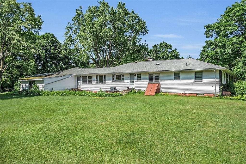 233 West Acton Road Stow, MA 01775 - Photo 36 of 41 a view of a house with a yard and potted plants