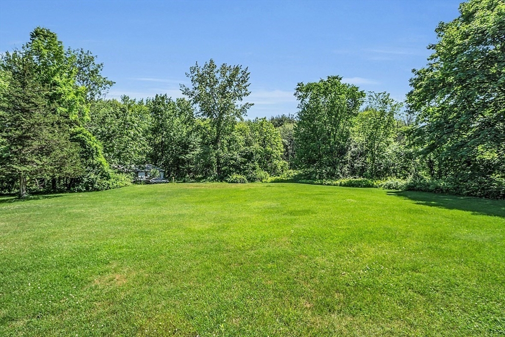 233 West Acton Road Stow, MA 01775 - Photo 4 of 41 a view of green field with trees in the background