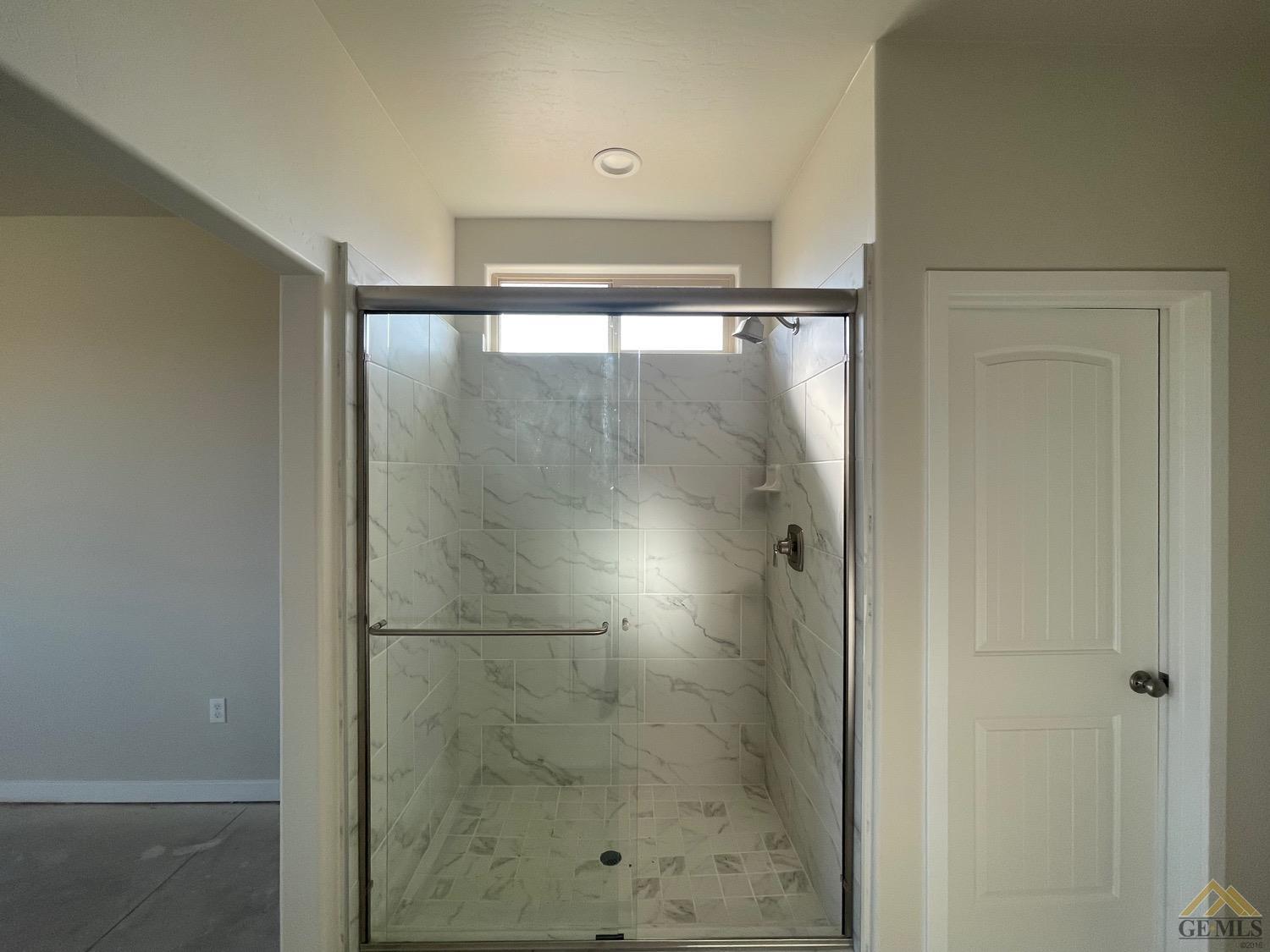 Undisclosed Address Bakersfield, CA 93311 - Photo 6 of 8 a bathroom with a glass shower door