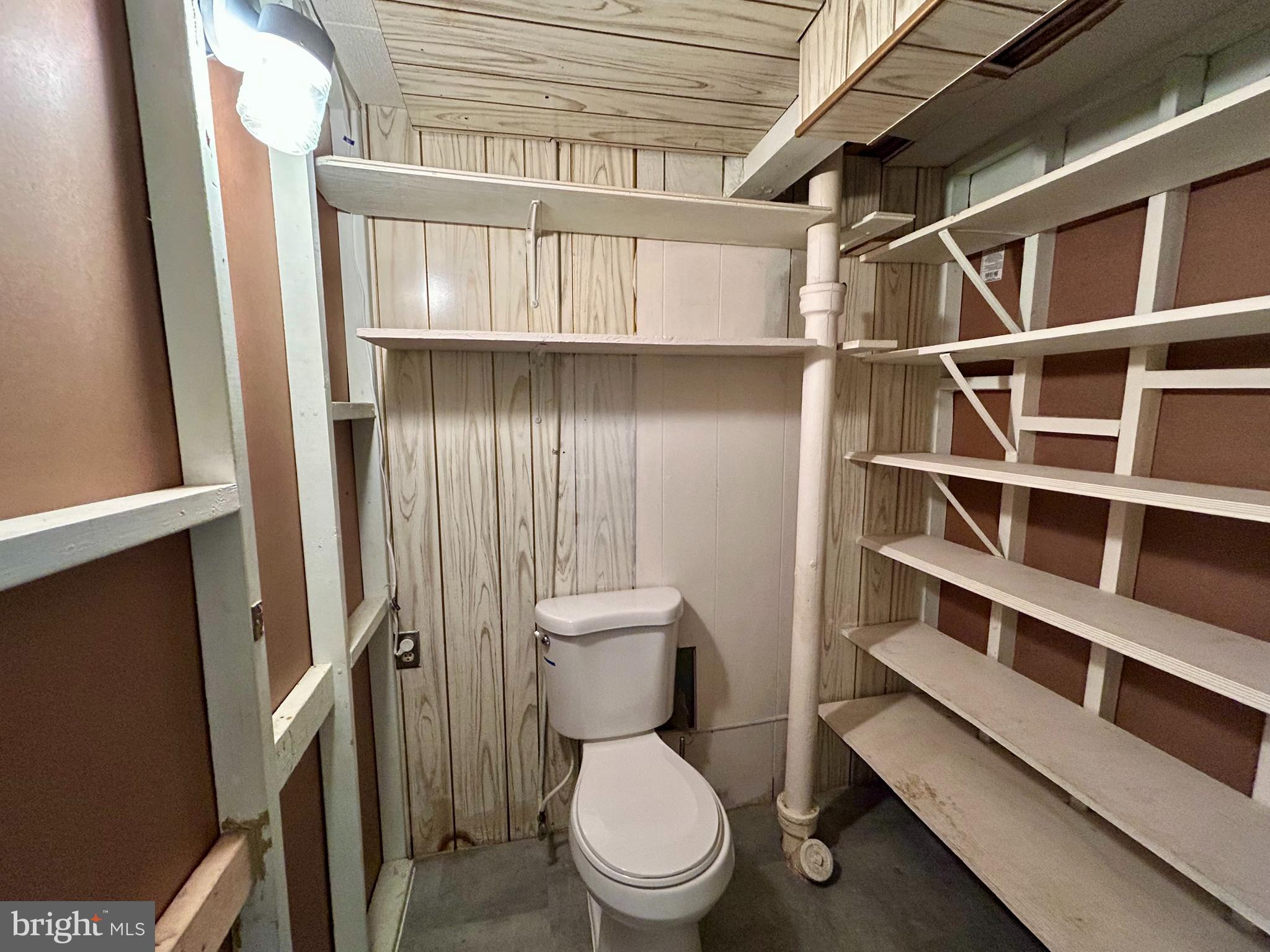 7242 Conley Street Baltimore, MD 21224 - Photo 13 of 18 a bathroom with a toilet and a shower