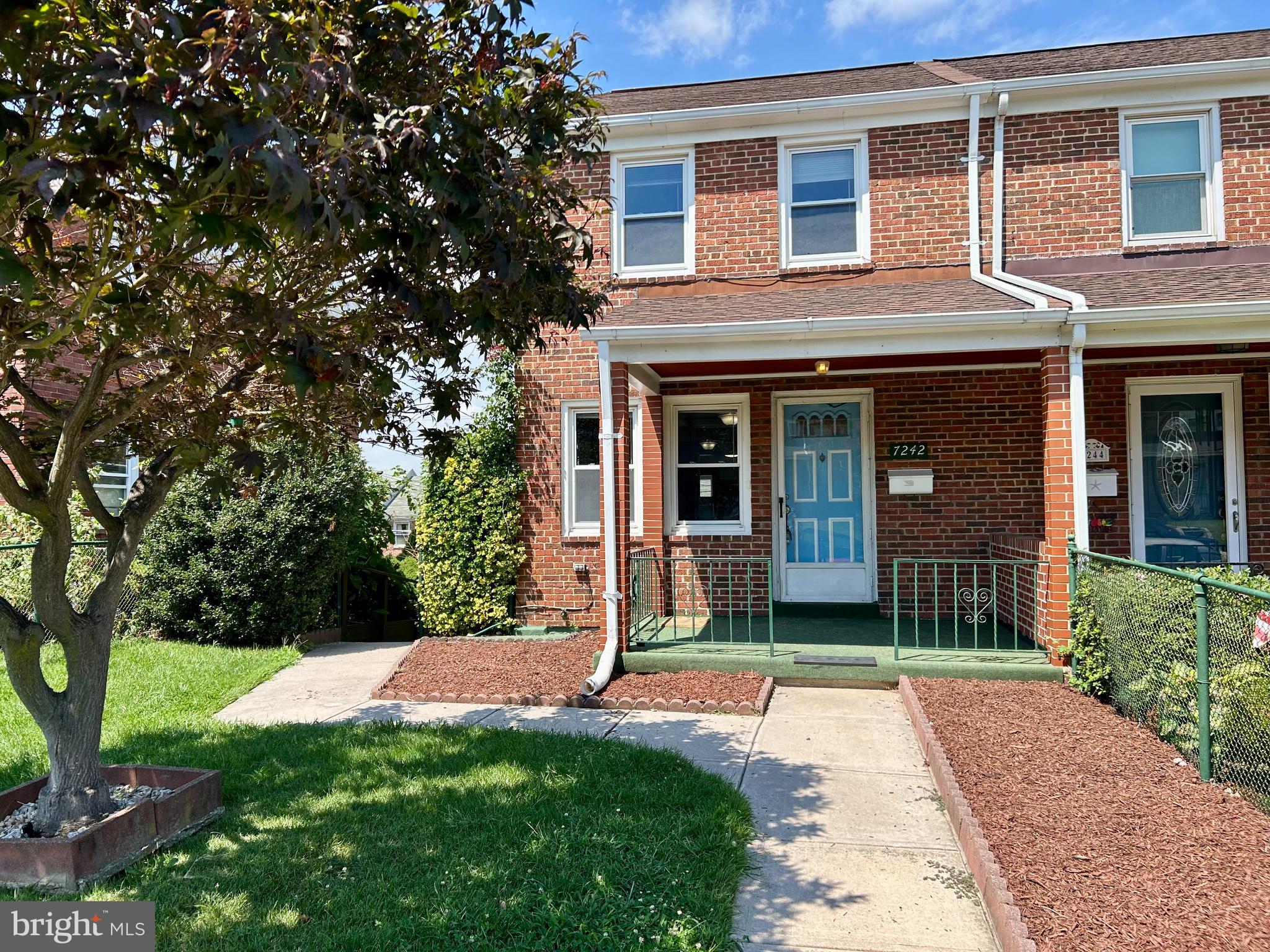 7242 Conley Street Baltimore, MD 21224 - Photo 2 of 18 a front view of a house with a yard