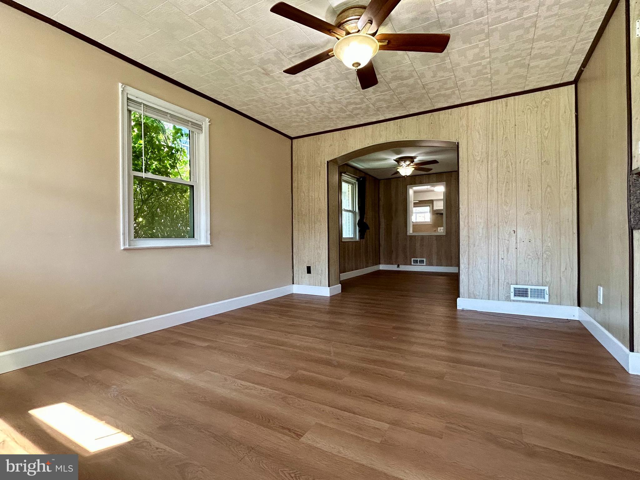 7242 Conley Street Baltimore, MD 21224 - Photo 3 of 18 an empty room with wooden floor and windows