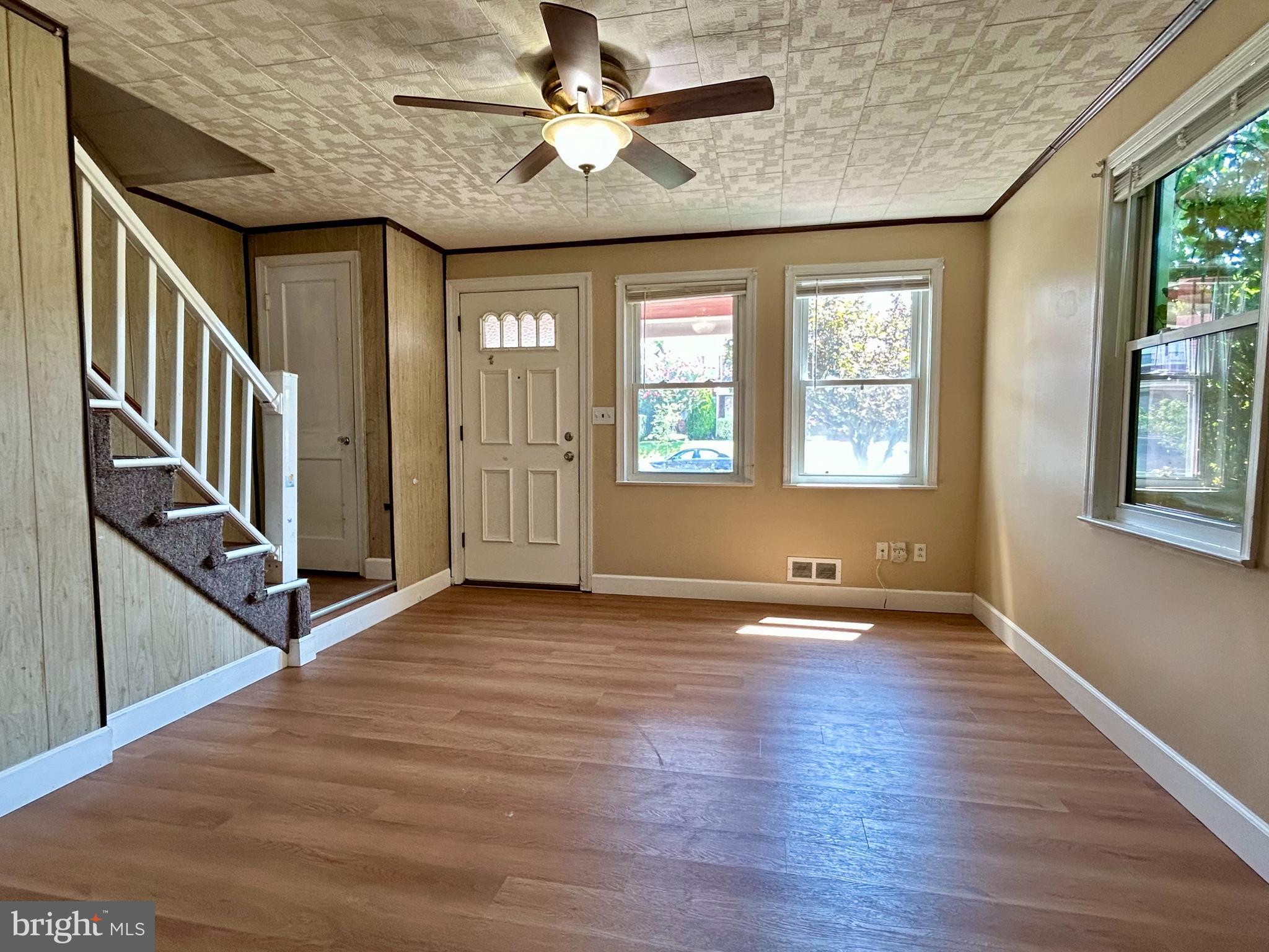 7242 Conley Street Baltimore, MD 21224 - Photo 4 of 18 an empty room with wooden floor and windows