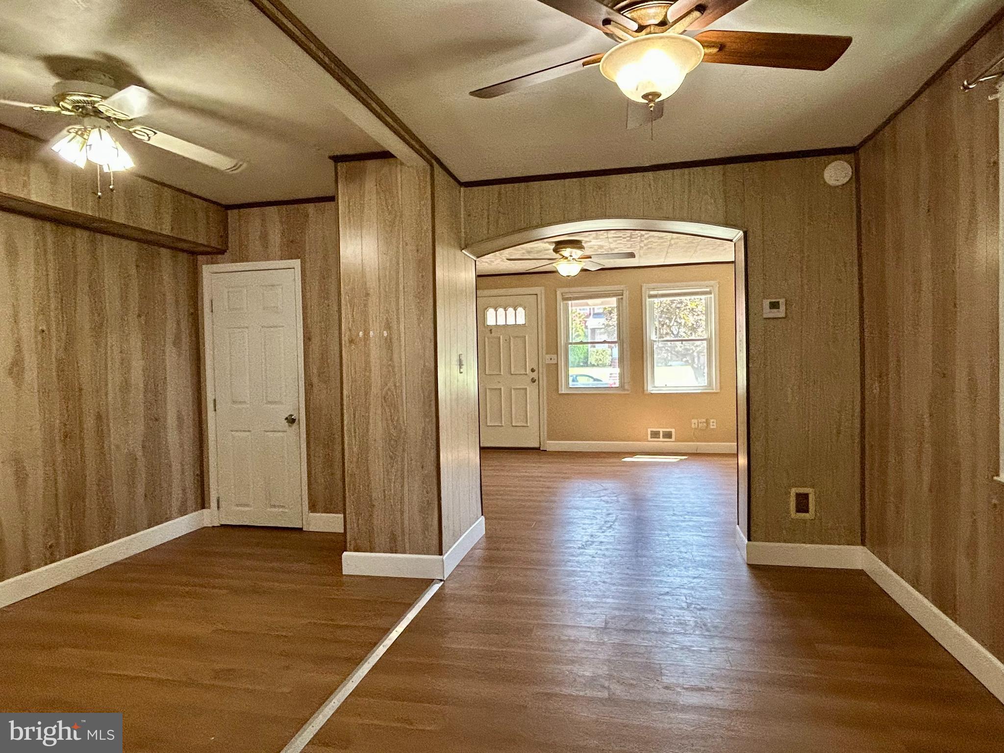 7242 Conley Street Baltimore, MD 21224 - Photo 6 of 18 a view of livingroom with hardwood floor and hallway