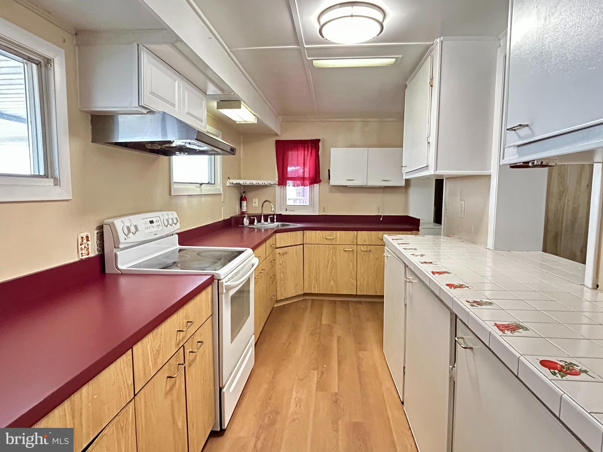 7242 Conley Street Baltimore, MD 21224 - Photo 7 of 18 a kitchen with a sink stove and cabinets