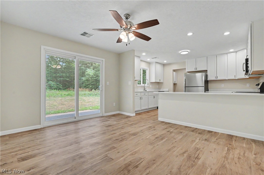 7583 Yale Road Atwater, OH 44201 - Photo 18 of 41 Dining room features a custom sliding glass door with built-in blinds. New 2026: paint, lighting, ceiling fan, flooring, and much more.