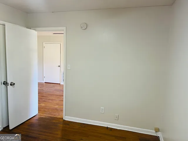 a view of a room with wooden floor