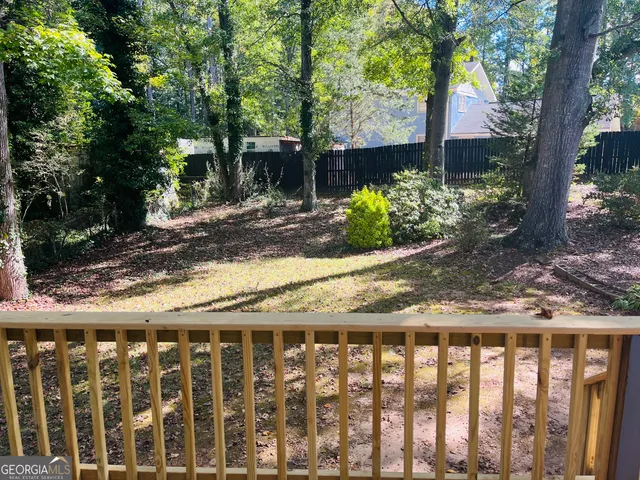a view of a wooden fence next to a yard