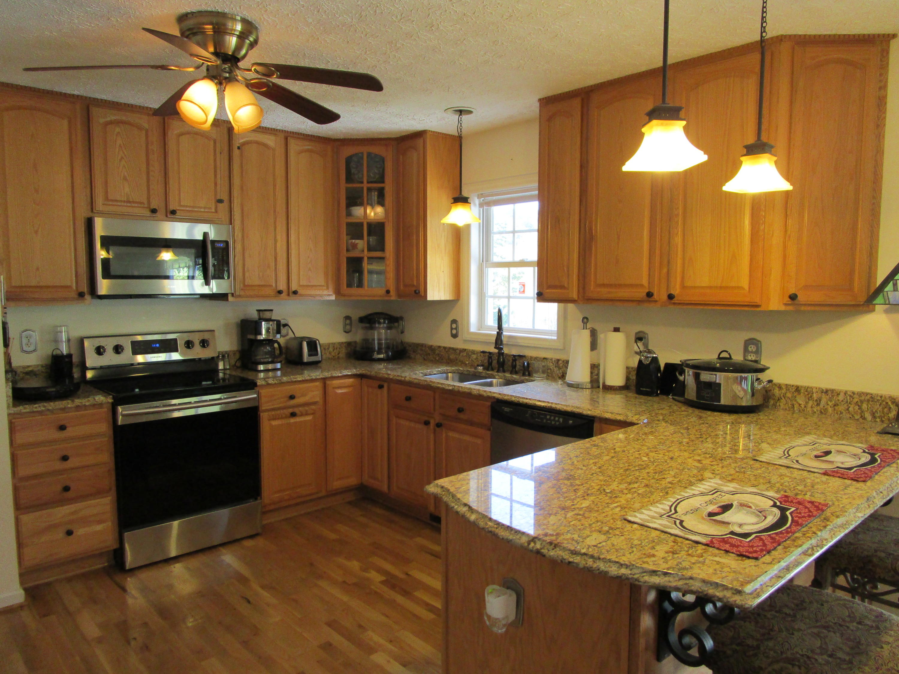 520 Green Level Road Boones Mill, VA 24065 - Photo 12 of 43 a kitchen with a stove a sink and a microwave