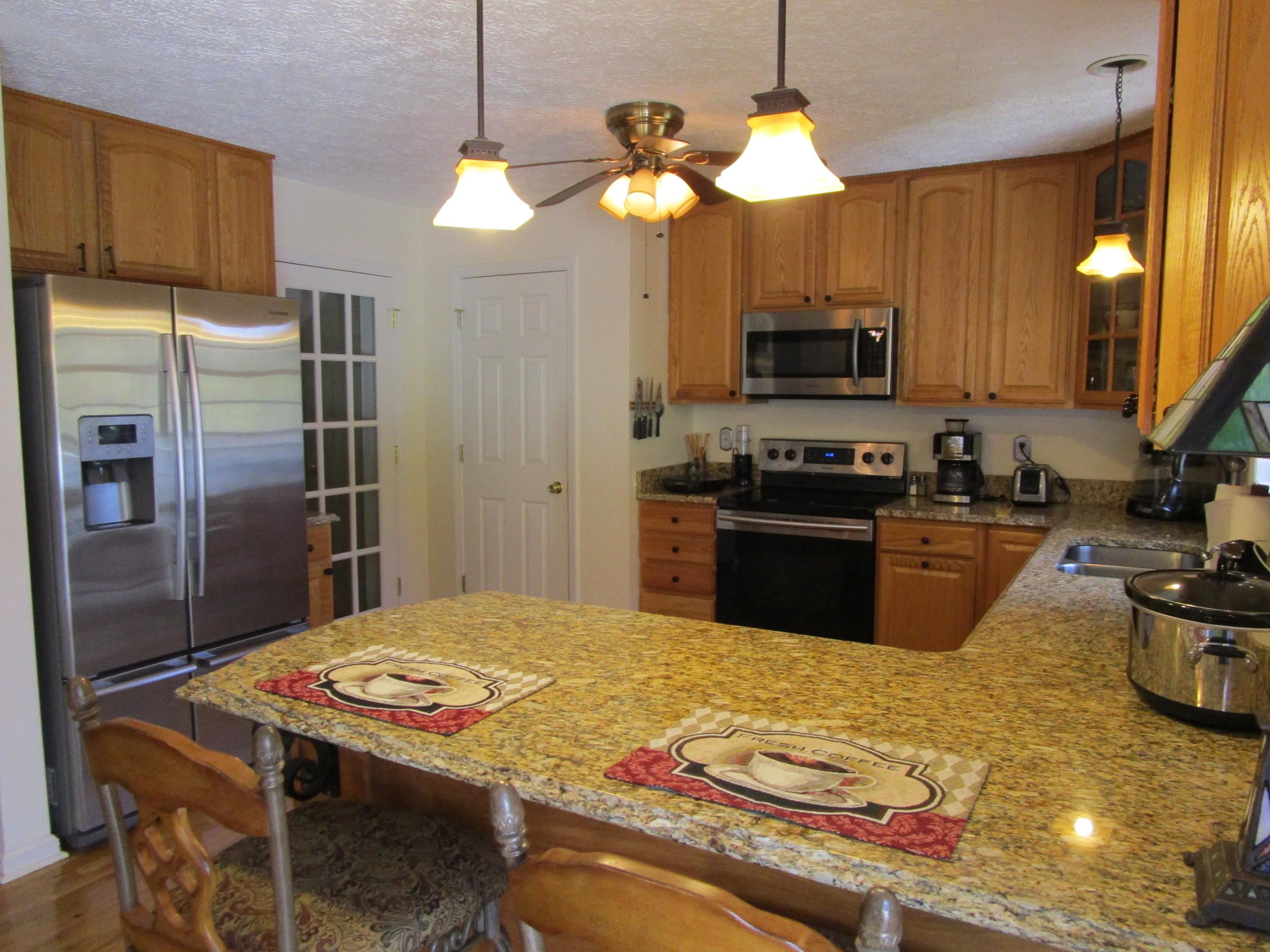 520 Green Level Road Boones Mill, VA 24065 - Photo 14 of 43 a kitchen with kitchen island a sink stove and refrigerator