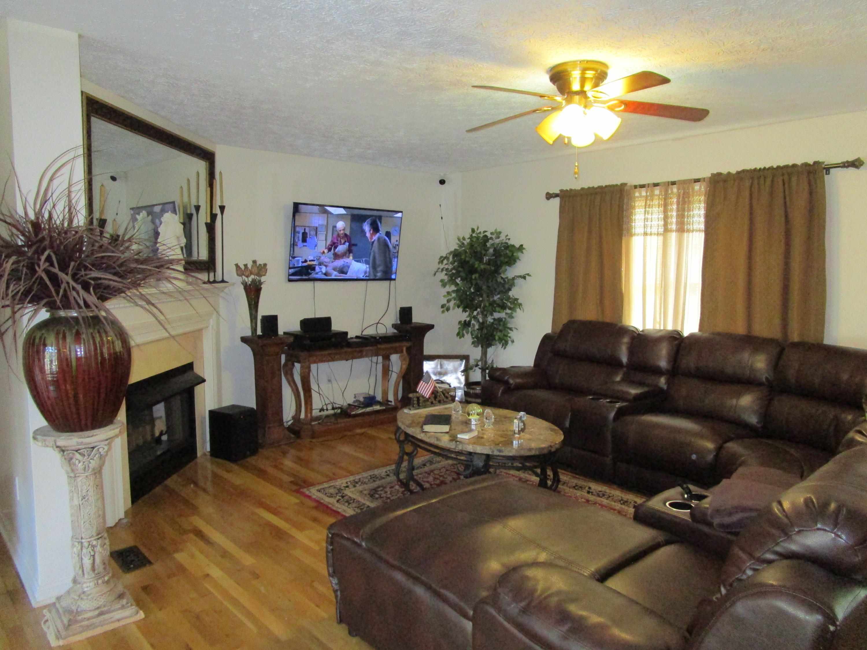520 Green Level Road Boones Mill, VA 24065 - Photo 21 of 43 a living room with furniture a chandelier and a fireplace