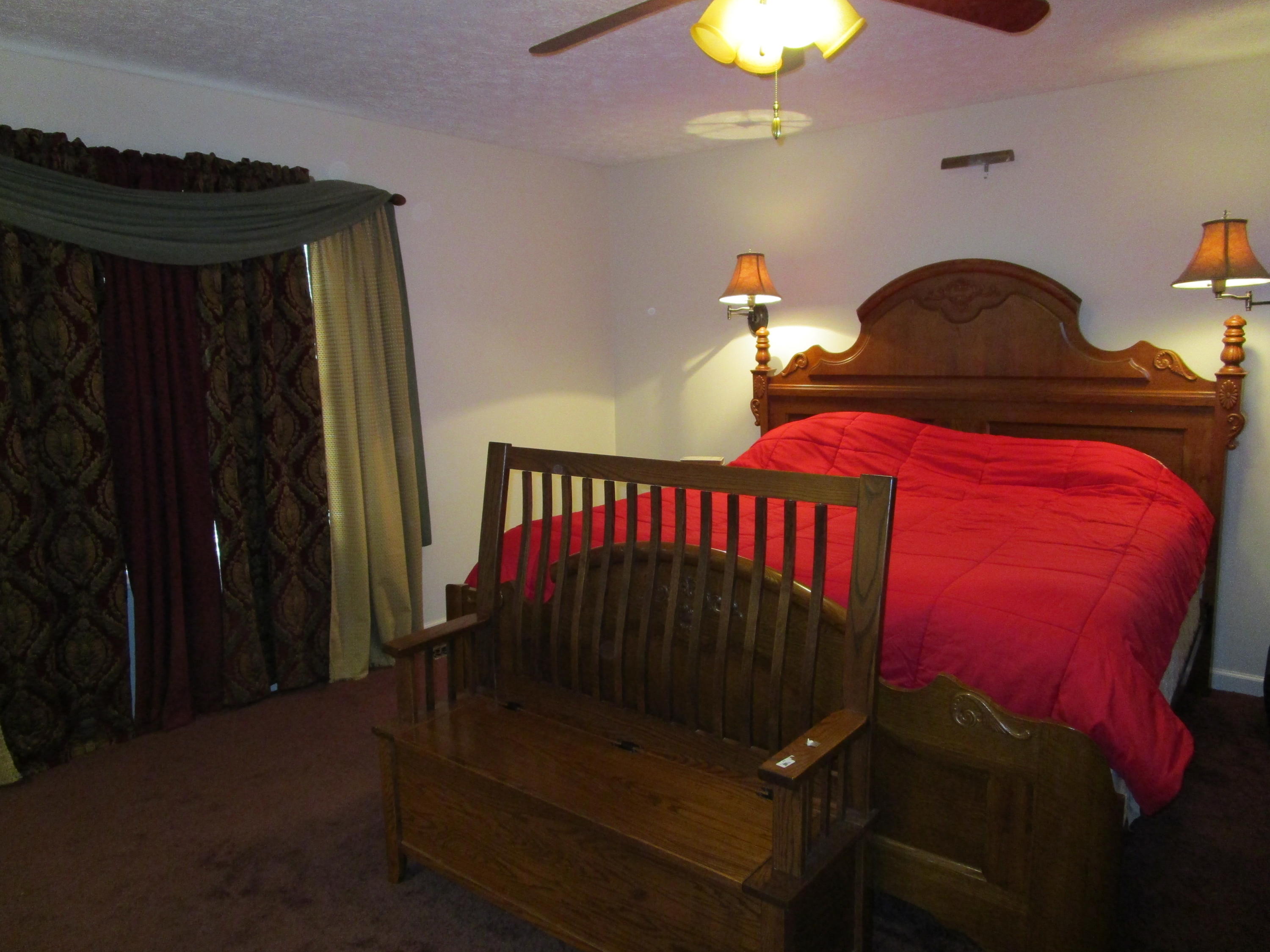 520 Green Level Road Boones Mill, VA 24065 - Photo 24 of 43 a bedroom with bed and a chandelier