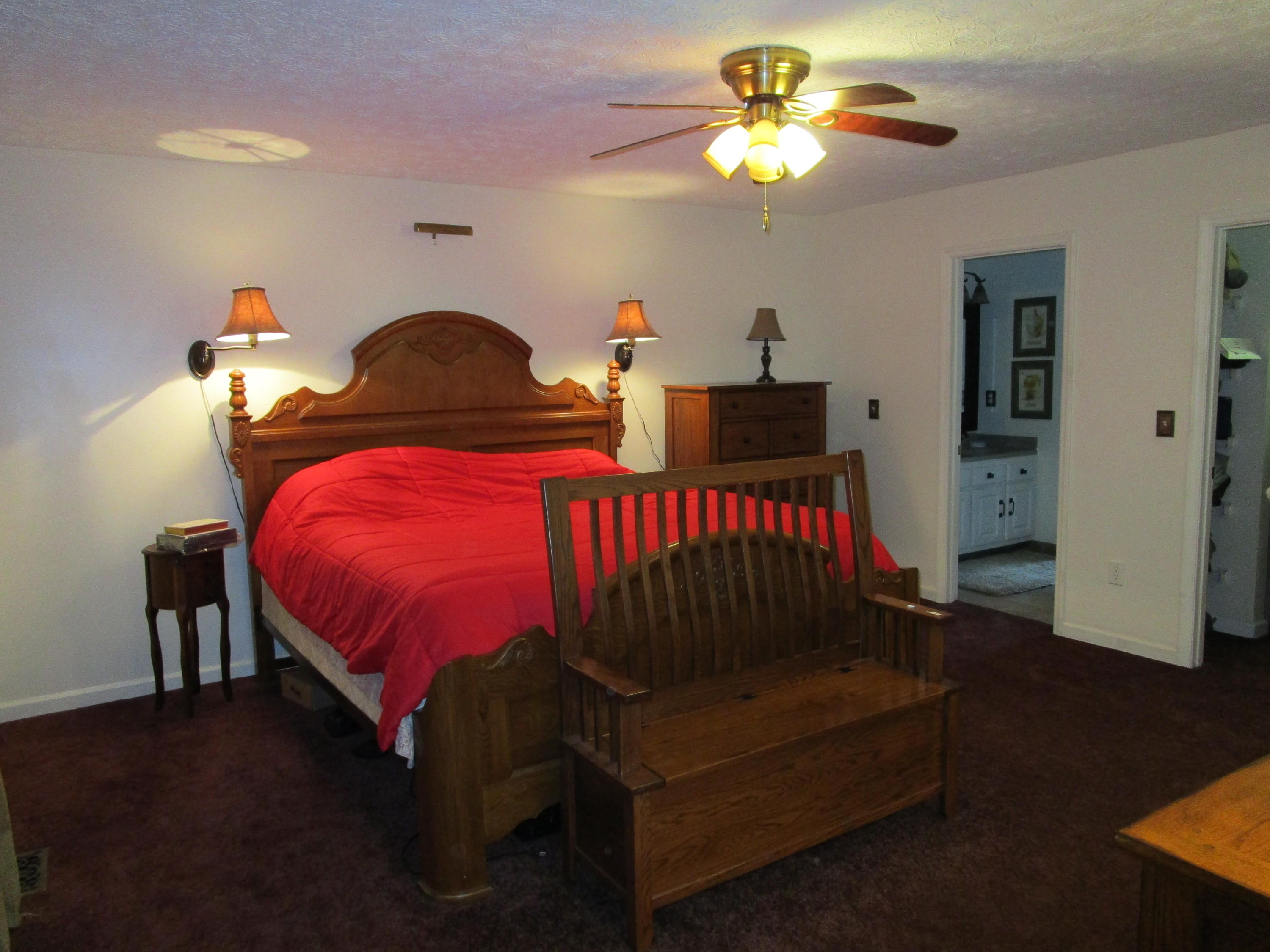 520 Green Level Road Boones Mill, VA 24065 - Photo 25 of 43 a bedroom with a bed and a chandelier