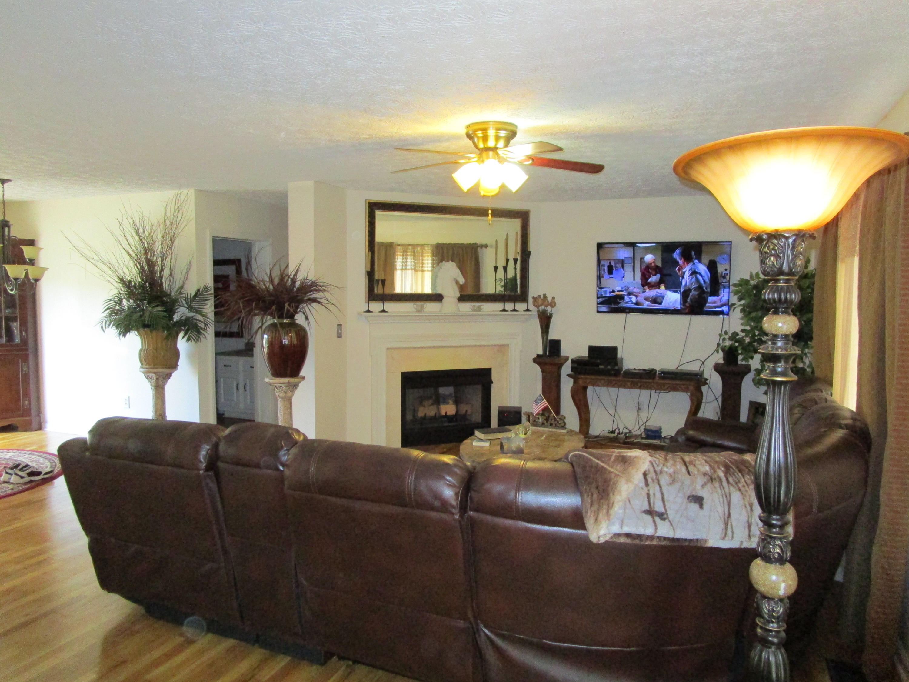 520 Green Level Road Boones Mill, VA 24065 - Photo 10 of 43 a living room with furniture a fireplace and a flat screen tv