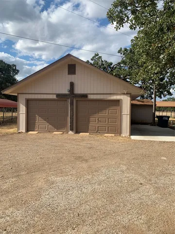 a view of garage yard and deck