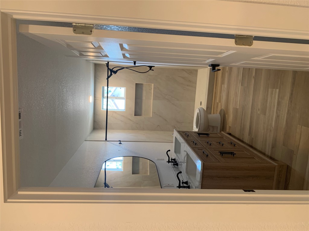 119 Faubion Drive, Unit B Georgetown, TX 78628 - Photo 5 of 7 a bathroom with a sink a toilet and a mirror