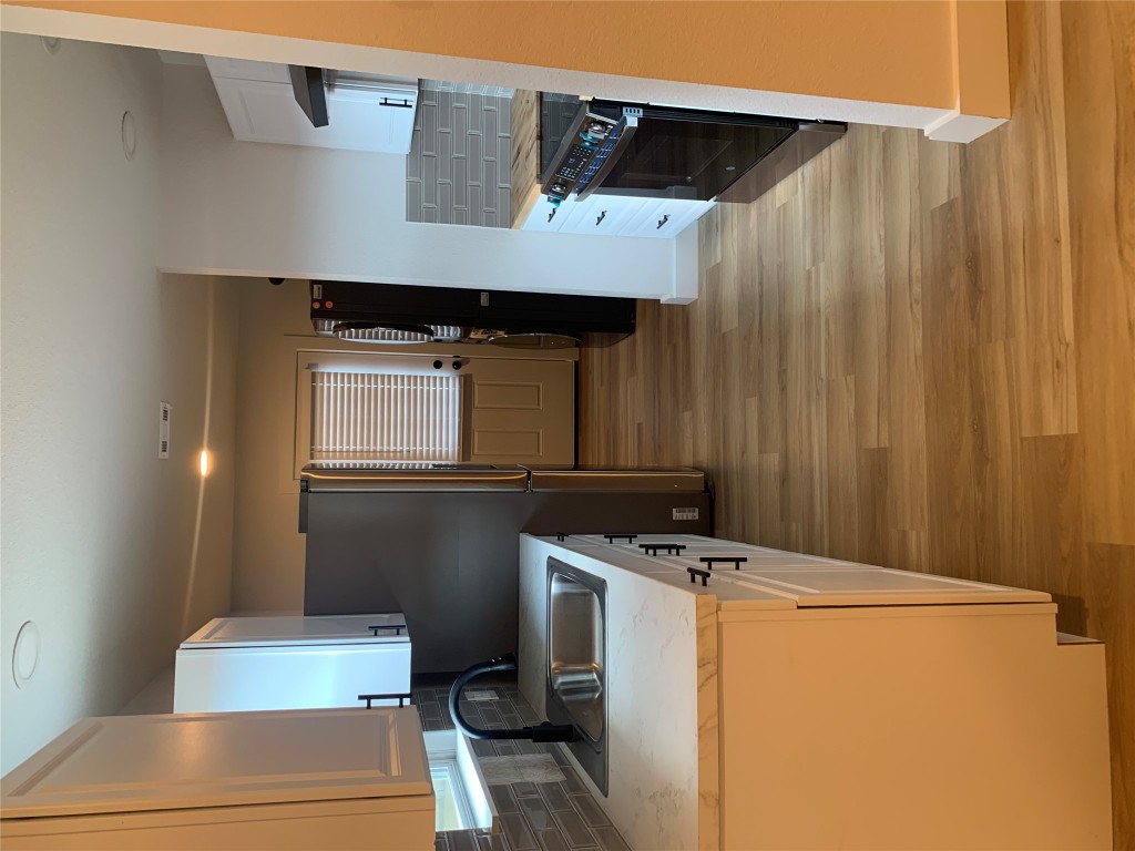 119 Faubion Drive, Unit B Georgetown, TX 78628 - Photo 6 of 7 a kitchen with stainless steel appliances granite countertop a sink stove and refrigerator