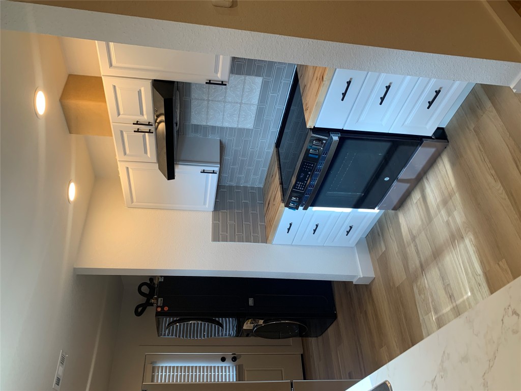 119 Faubion Drive, Unit B Georgetown, TX 78628 - Photo 7 of 7 a kitchen with stainless steel appliances granite countertop a stove and a refrigerator