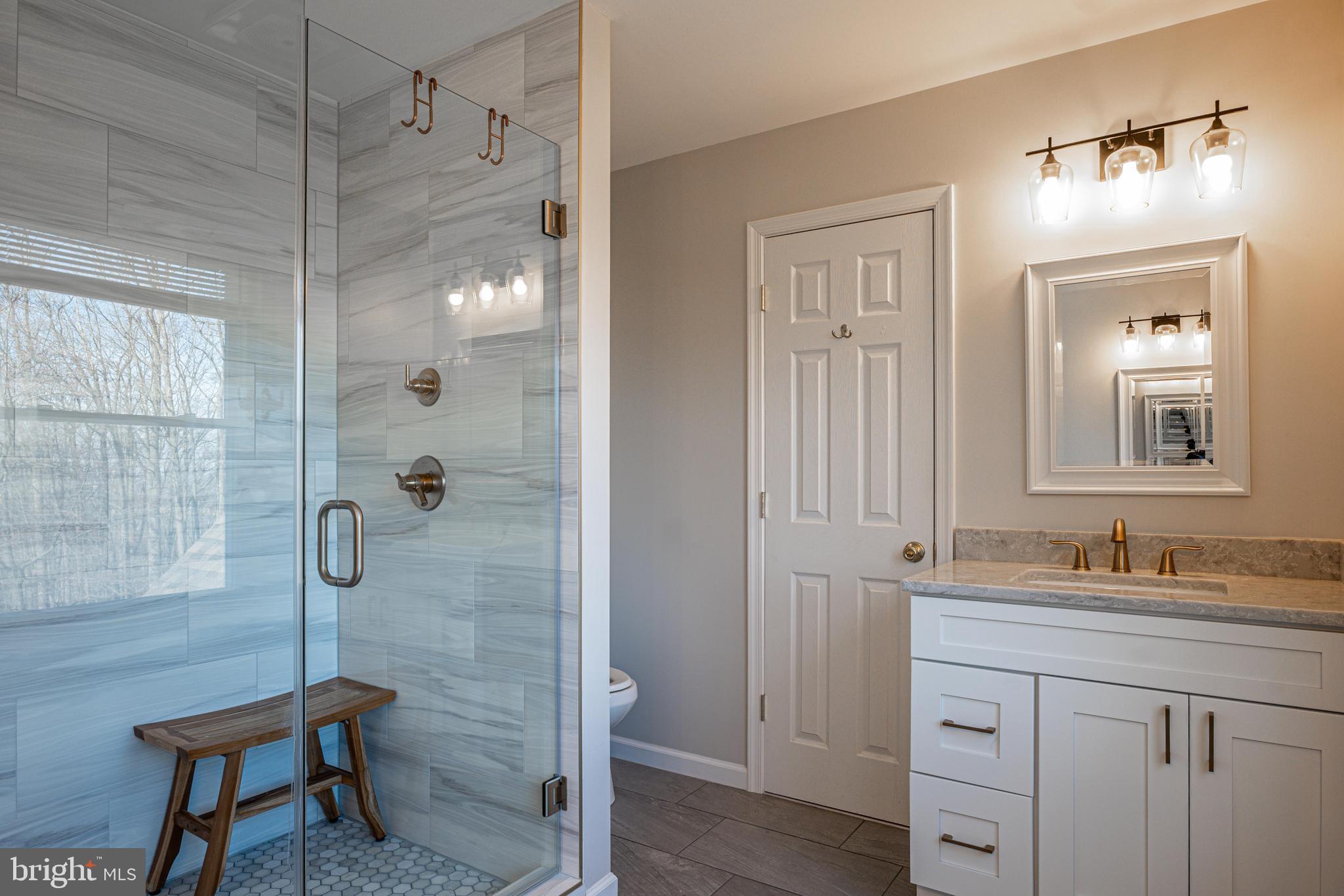 9833 Fox Road Frederick, MD 21702 - Photo 18 of 48 a bathroom with a shower sink and mirror