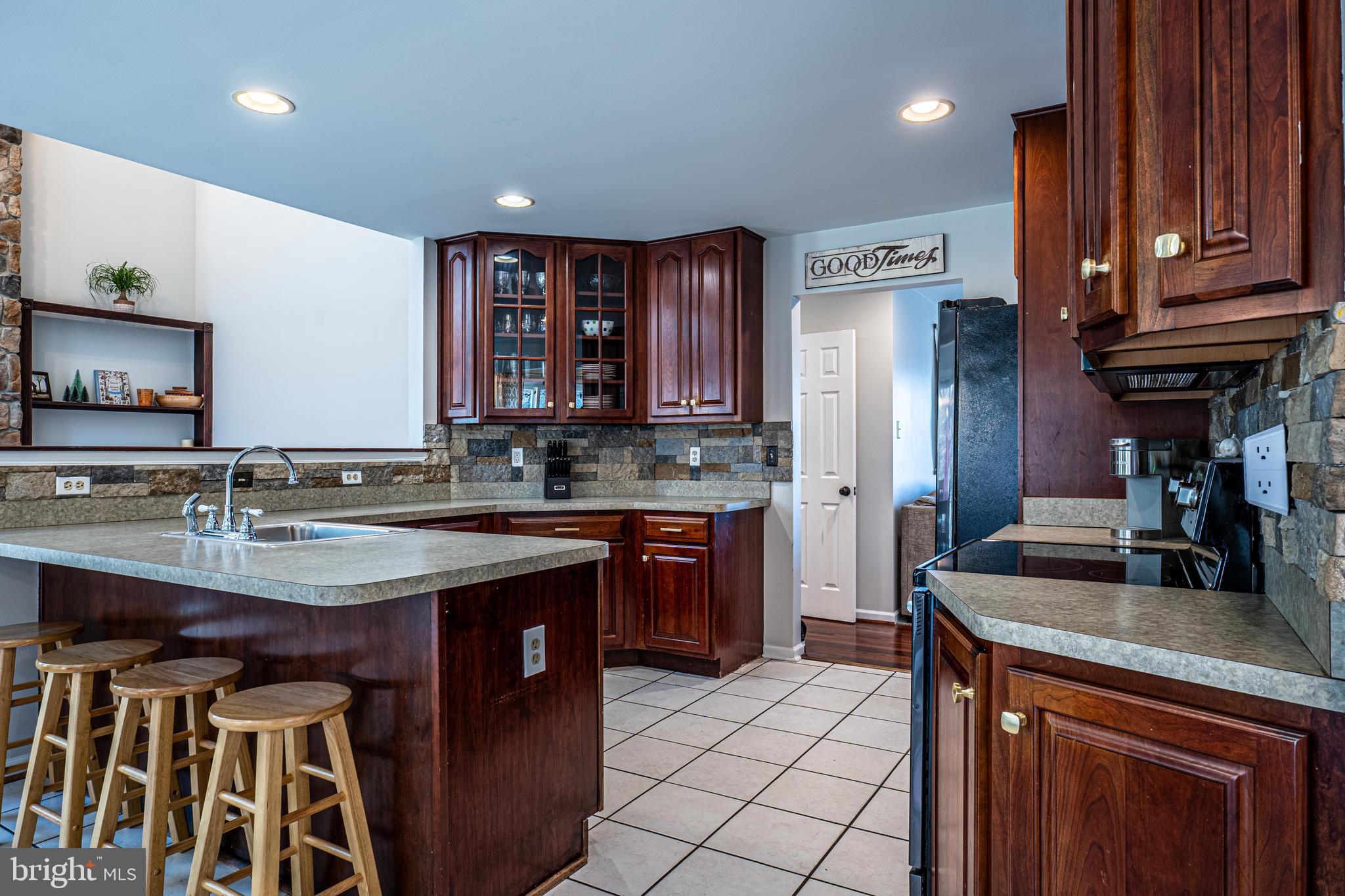 9833 Fox Road Frederick, MD 21702 - Photo 24 of 48 a kitchen with stainless steel appliances granite countertop a sink stove and refrigerator