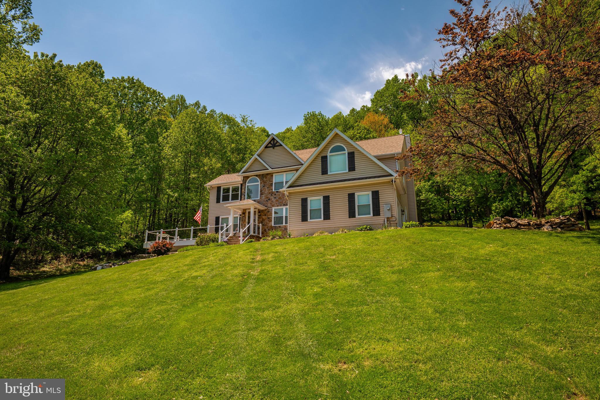 9833 Fox Road Frederick, MD 21702 - Photo 3 of 48 a front view of a house with a garden