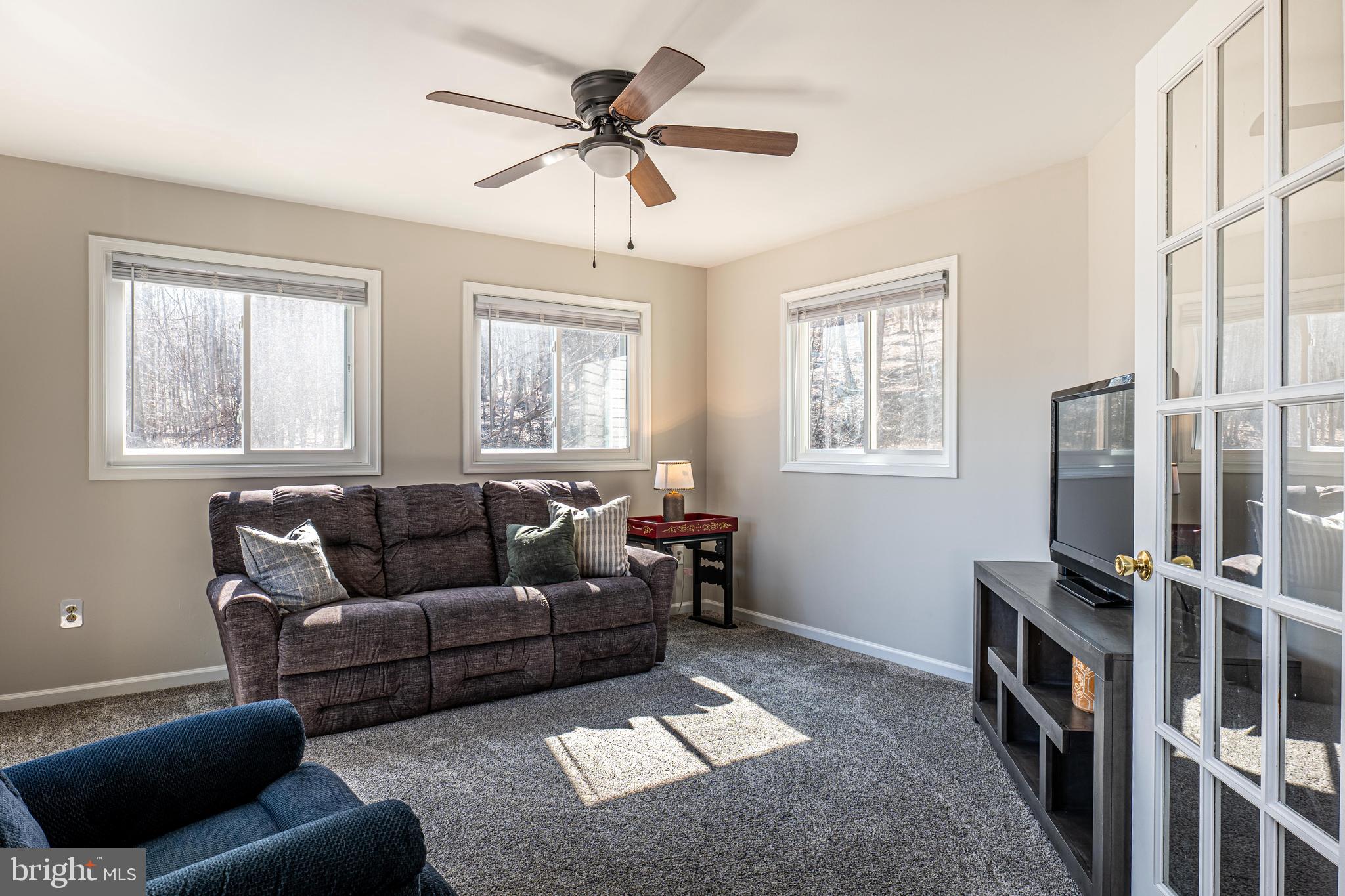 9833 Fox Road Frederick, MD 21702 - Photo 32 of 48 a living room with furniture and a flat screen tv