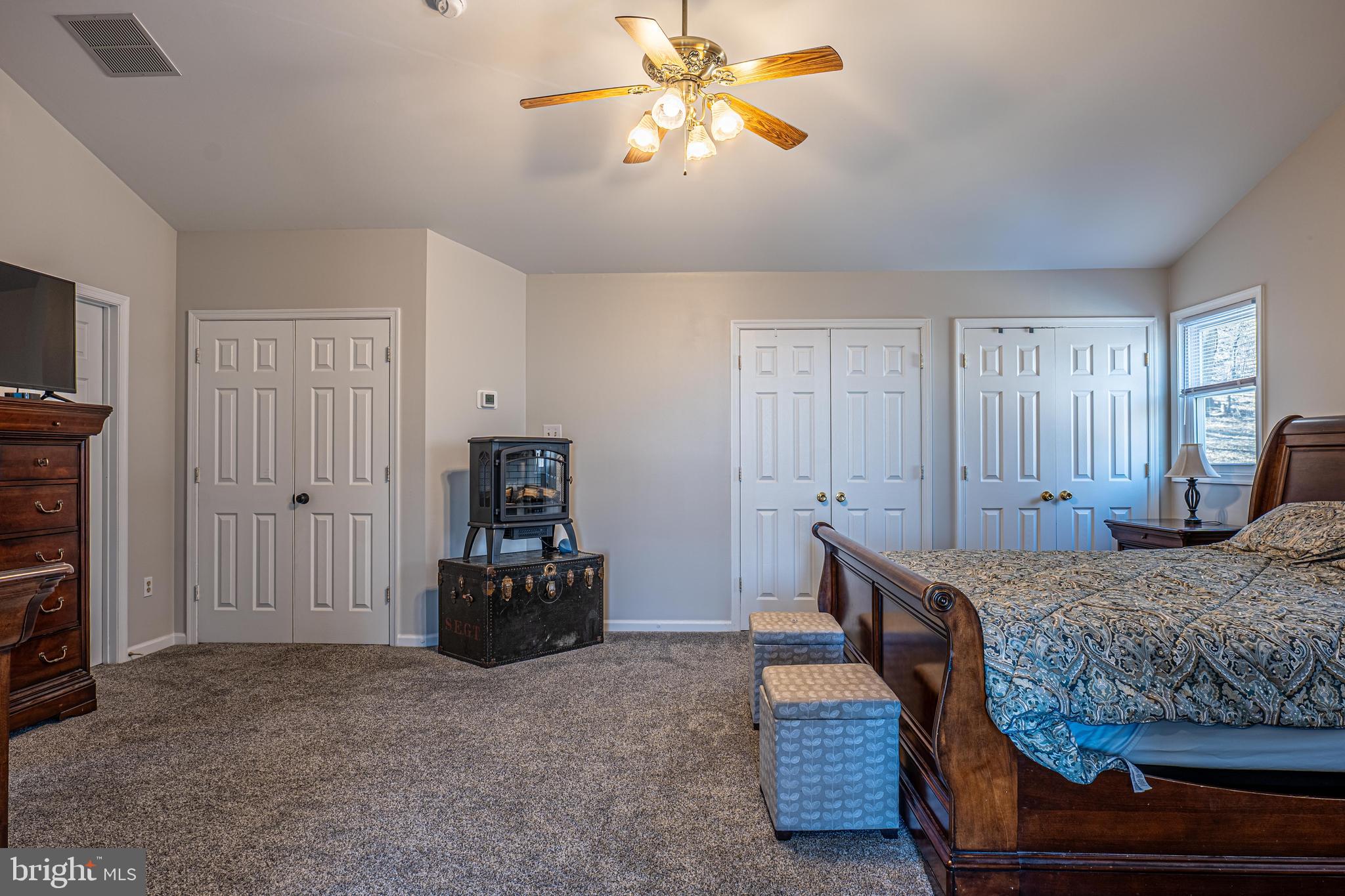 9833 Fox Road Frederick, MD 21702 - Photo 36 of 48 a bedroom with a bed and a chandelier