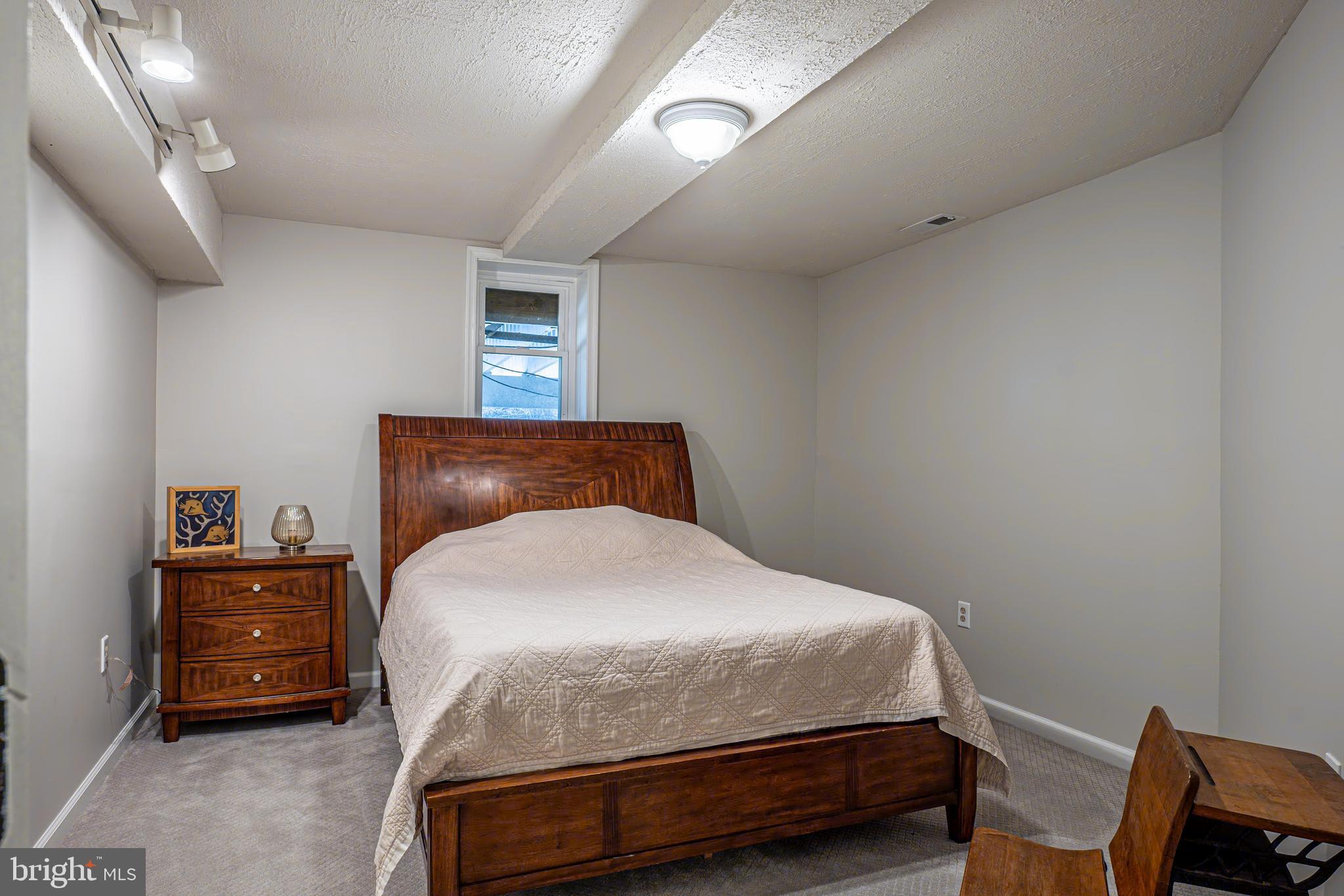 9833 Fox Road Frederick, MD 21702 - Photo 44 of 48 a bedroom with a bed and a chair