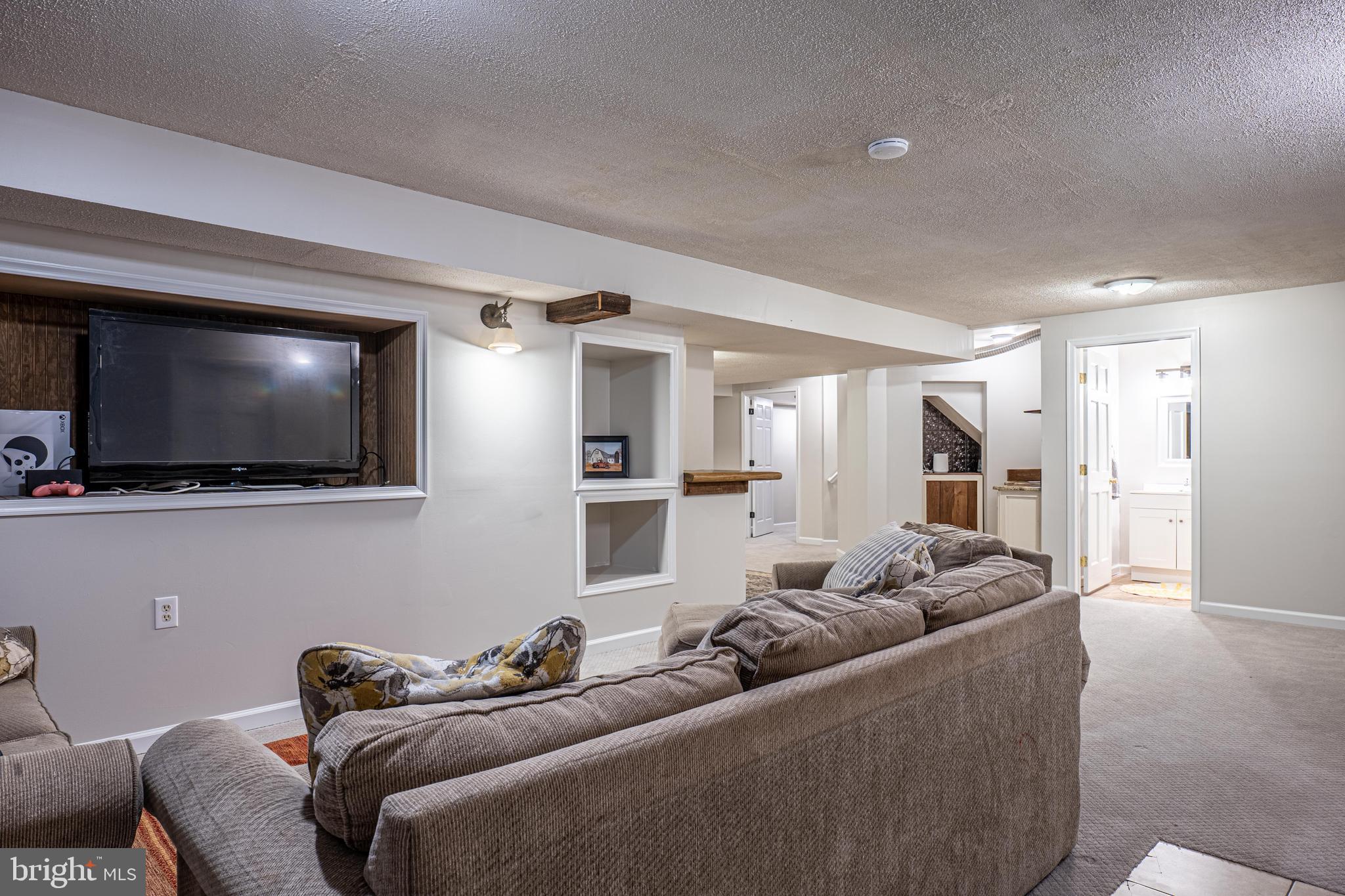 9833 Fox Road Frederick, MD 21702 - Photo 45 of 48 a living room with furniture and a flat screen tv