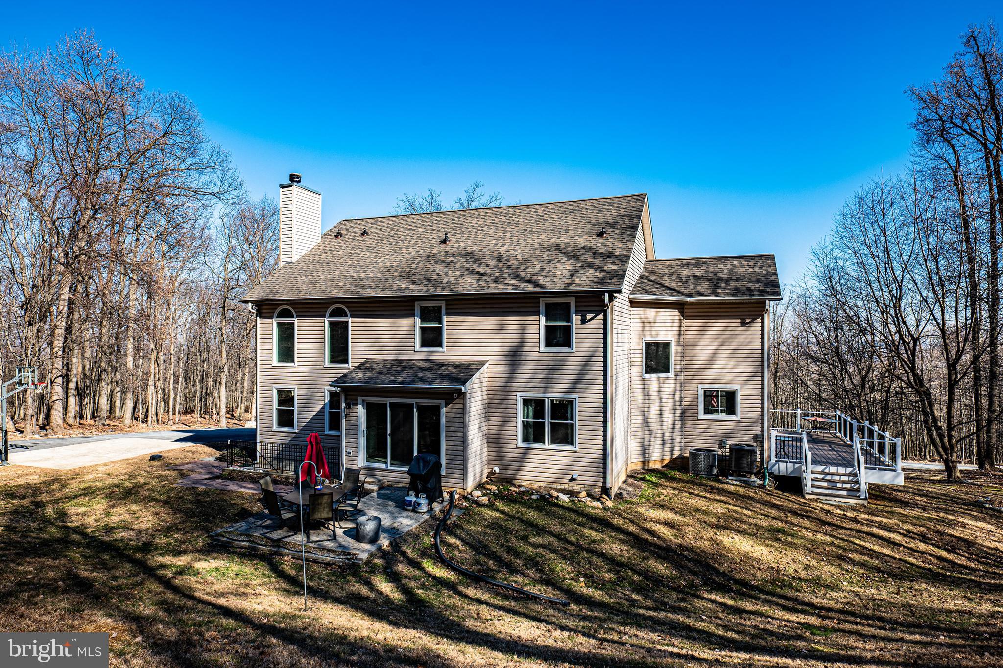 9833 Fox Road Frederick, MD 21702 - Photo 6 of 48 a view of a white house with a large windows next to a yard
