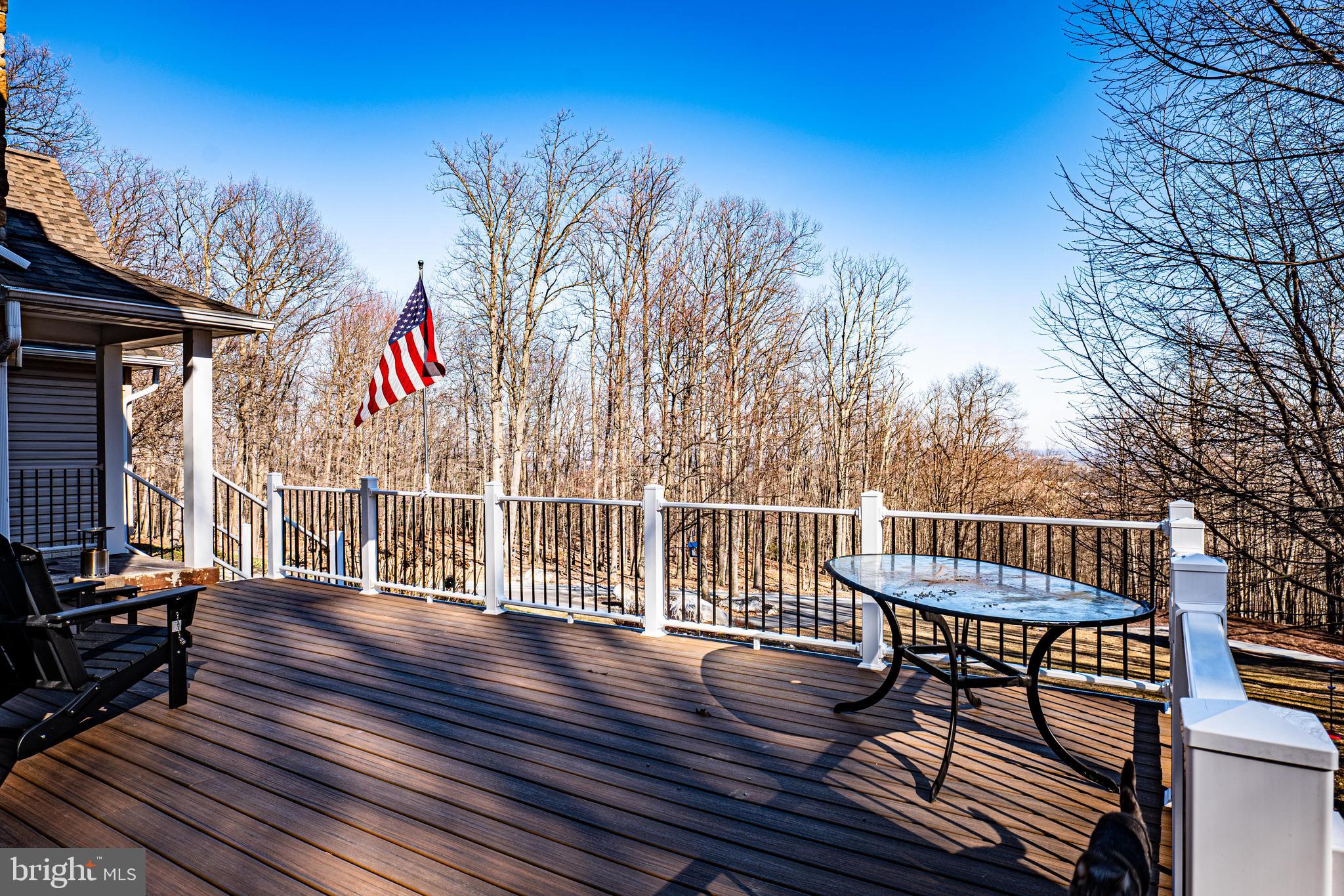 9833 Fox Road Frederick, MD 21702 - Photo 9 of 48 a view of a chairs and table on the wooden deck