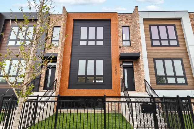a view of a brick house with many windows