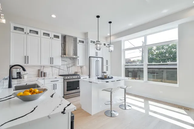 a kitchen with stainless steel appliances granite countertop a stove and a sink