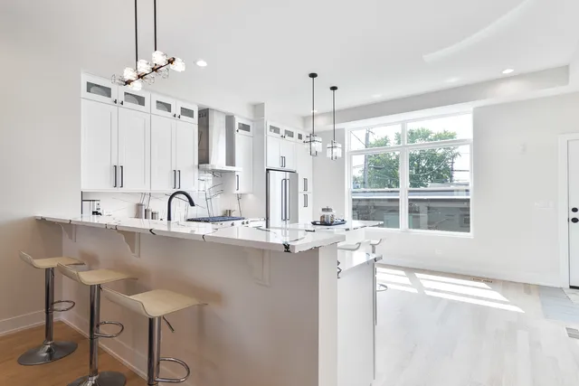 a kitchen with stainless steel appliances a sink and cabinets