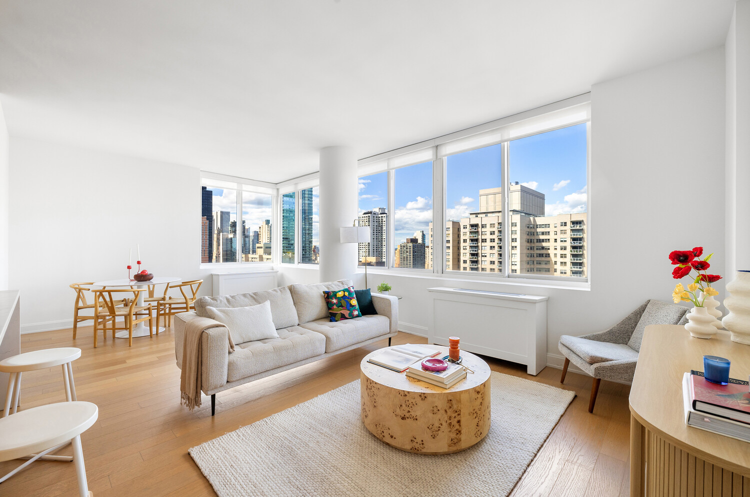 420 East 54th Street, Unit PH6 Manhattan, NY 10022 - Photo 1 of 10 a living room with furniture and a large window