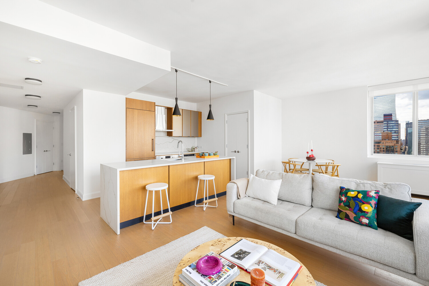 420 East 54th Street, Unit PH6 Manhattan, NY 10022 - Photo 3 of 10 a living room with furniture and a wooden floor