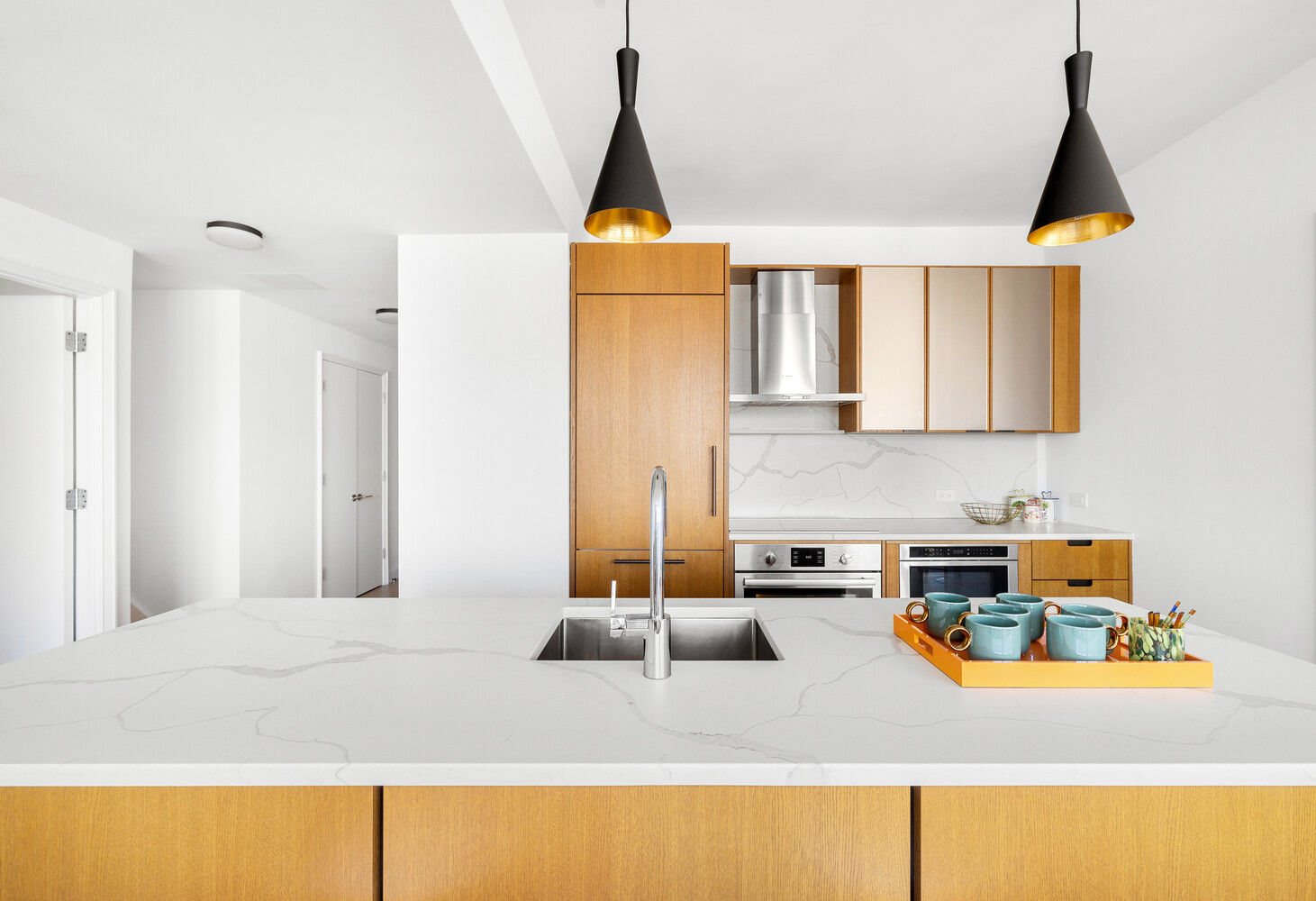 420 East 54th Street, Unit PH6 Manhattan, NY 10022 - Photo 4 of 10 a kitchen with a sink a counter top space and a lamp