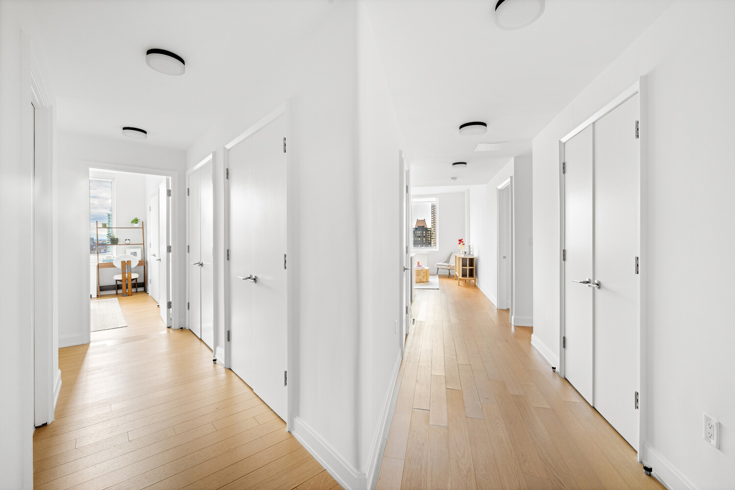 420 East 54th Street, Unit PH6 Manhattan, NY 10022 - Photo 6 of 10 a view of a hallway with wooden floor and a bathroom
