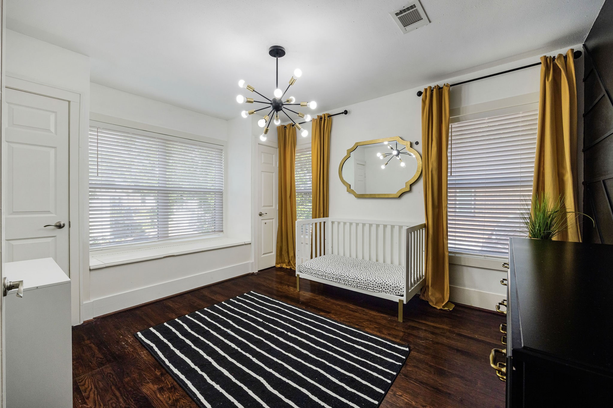 2613 Wichita Street Houston, TX 77004 - Photo 15 of 25 Spacious secondary bedroom with hardwood floors, large windows, and generous natural light.