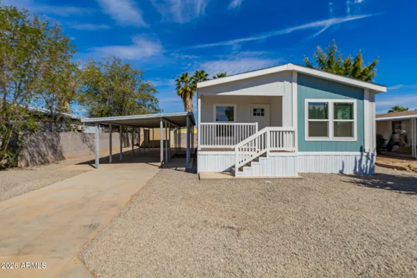 a view of house with backyard and sitting area