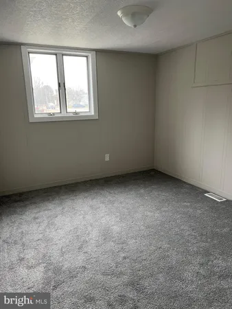 a bathroom with a window a toilet and a shower