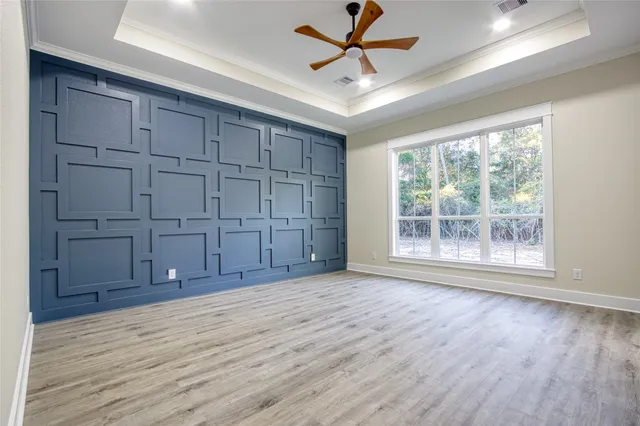 a view of a room with wooden floor and fan