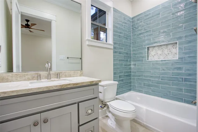a bathroom with a granite countertop toilet a sink and bathtub