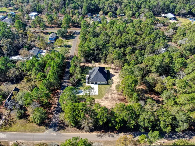 a aerial view of a house with a yard and garden