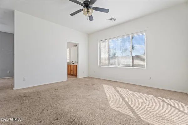 a bedroom with a bed and chair