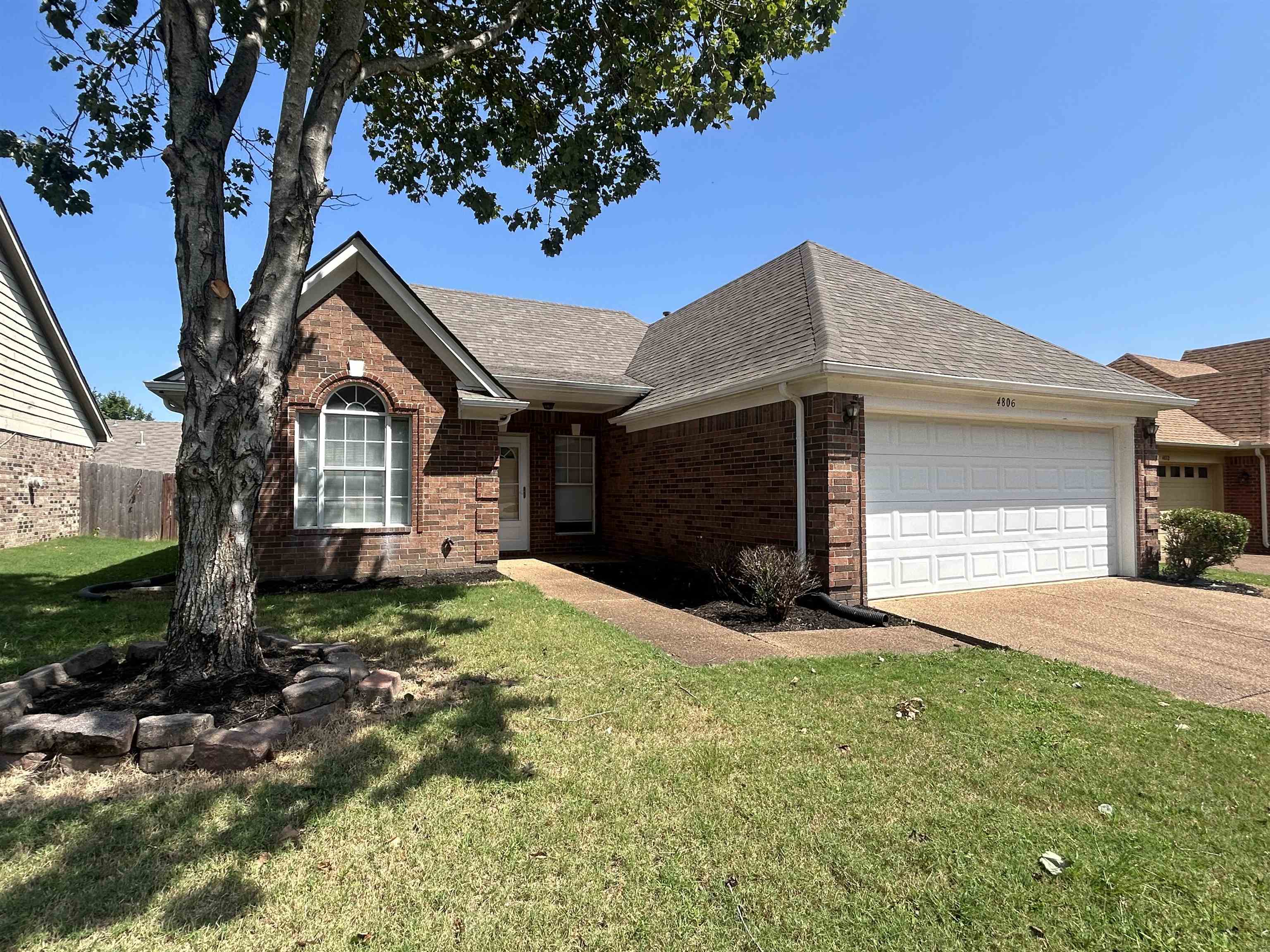 4806 Ashcroft Drive Memphis, TN 38125 - Photo 1 of 18 a front view of a house with a yard and garage
