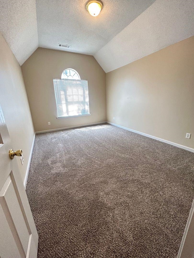4806 Ashcroft Drive Memphis, TN 38125 - Photo 12 of 18 an empty room with windows and entrance