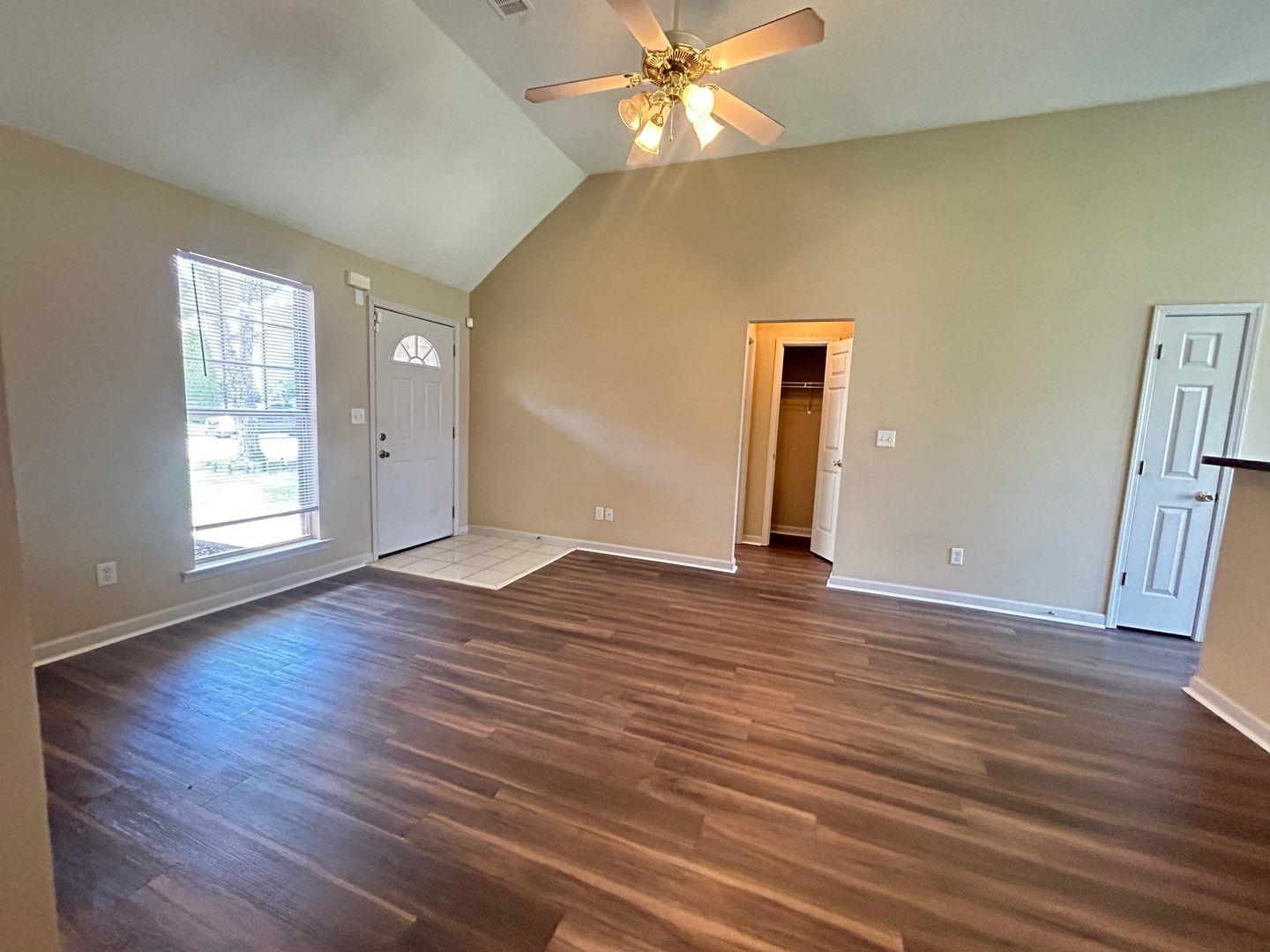 4806 Ashcroft Drive Memphis, TN 38125 - Photo 6 of 18 an empty room with wooden floor and windows