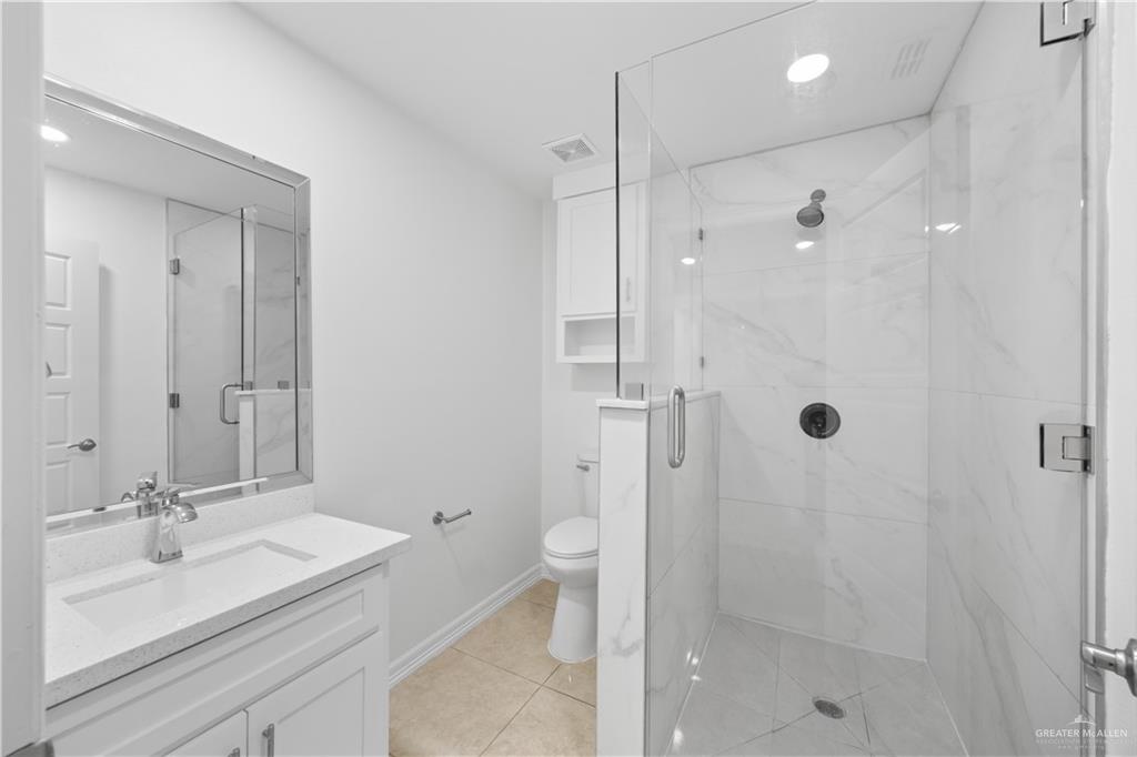 2902 Alejandra Street Mission, TX 78574 - Photo 12 of 17 a bathroom with a sink a toilet and shower