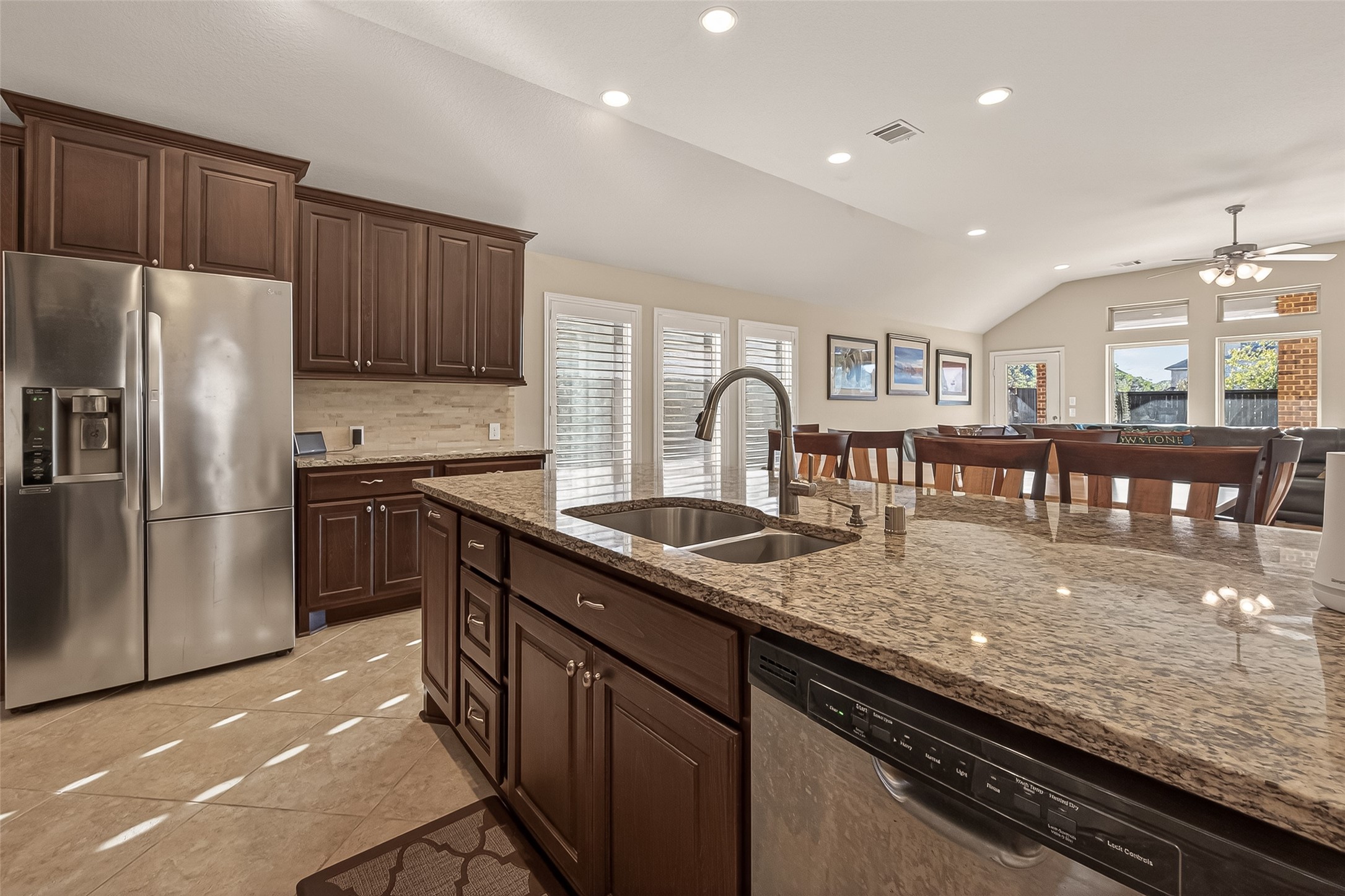 28435 Sycamore Falls Lane Fulshear, TX 77441 - Photo 16 of 46 a kitchen with granite countertop stainless steel appliances and wooden cabinets